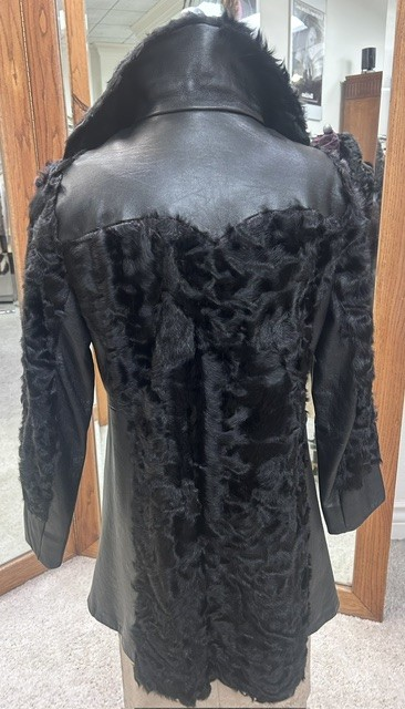 Back of vintage black Spanish lamb fur coat #1767 showing leather shoulder panel and cuffs